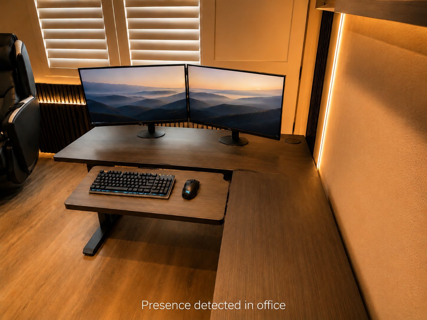 Home office with warm lighting and two monitors switched on, labelled presence detected in office